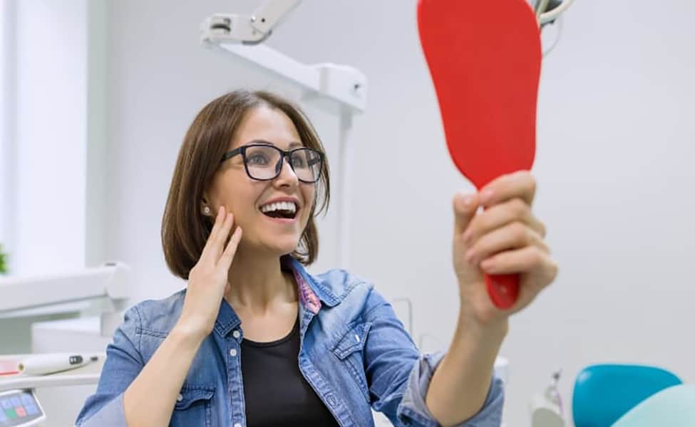 Canva Woman Patient Looking in the Mirror at the Teeth Sitting in the Dental Chair. Healthcare Medical and Dentistry Concept 1 1
